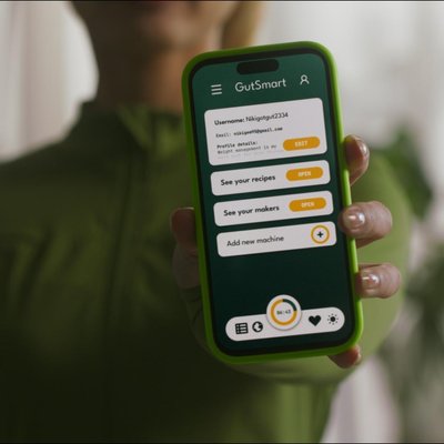 Artistic side view of GutSmart yogurt maker against blue background highlighting minimalist design